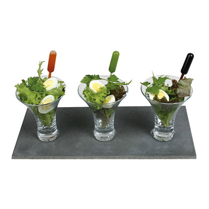 Three martini glasses with leafy greens and boiled eggs are each equipped with a Starpak 100 Pipette, PE transparent from Starpak for precise dosing of the dressing. All glasses are neatly arranged on a rectangular slate plate.