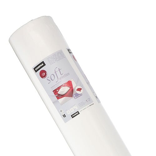 A roll of white Starpak tablecloth, fabric-like, fleece 'Soft Selection' (40 m x 0.9 m) is depicted upright in its box, with product details and an image of a made bed on the packaging against a white background.