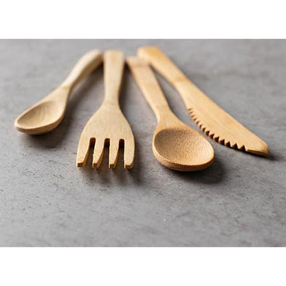 Four wooden utensils - a spoon, a fork, another spoon, and a PAPSTAR bamboo knife "pure" 16 cm - are arranged on a gray stone surface. The environmentally friendly disposable knives from PAPSTAR GmbH are light brown and have a smooth, polished surface.