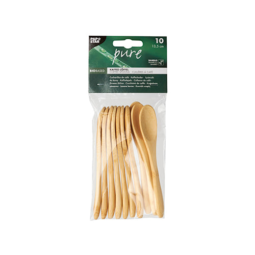 A transparent bag contains 10 PAPSTAR "pure" bamboo coffee spoons (13.5 cm), environmentally friendly and stacked, with a green and white label on the top. The sustainable spoons are sealed in packaging by PAPSTAR GmbH.