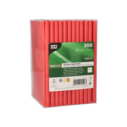 A transparent plastic box with 200 red PAPSTAR cocktail straws (paper straws, Ø7 mm, 15 cm) from PAPSTAR GmbH, with a green-white label with product information, barcode, and "Cocktail Straws" - an eco-friendly choice for your drinks.
