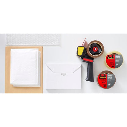 A roll of bubble wrap, white paper sheets, a closed white envelope, a box, a tape dispenser, and two rolls of 3M Deutschland GmbH Scotch® all-purpose tape (48 mm x 66 m) are arranged on a white surface.