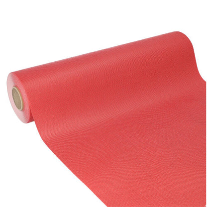 The Starpak table runner, fabric-like, fleece 'soft selection plus' (24 m x 40 cm) is partially unrolled, the cardboard core is visible. Its slightly textured red surface is ideal as a table runner for special occasions.