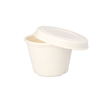 A small, white PAPSTAR "pure" sugarcane dressing cup lid from PAPSTAR GmbH with a smooth, matte surface and simple design is partially open on a matching cup against a white background.