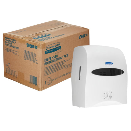 Ein Karton der Kimberly-Clark GmbH mit der Aufschrift "Kimberly-Clark Professional™ Elektronische No Touch - Losse Module - Rolle / Weiß" ist neben einem weißen Spender mit einem schwarzen Fenster und Hygienesymbolen auf der Vorderseite abgebildet.