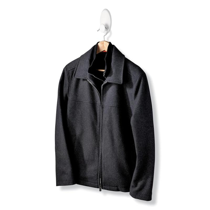 A black jacket with a zipper and collar hangs on a wooden hanger of the Command™ Clothes Hook, 17019-FGN, which allows wall mounting without drilling, against a simple white background.