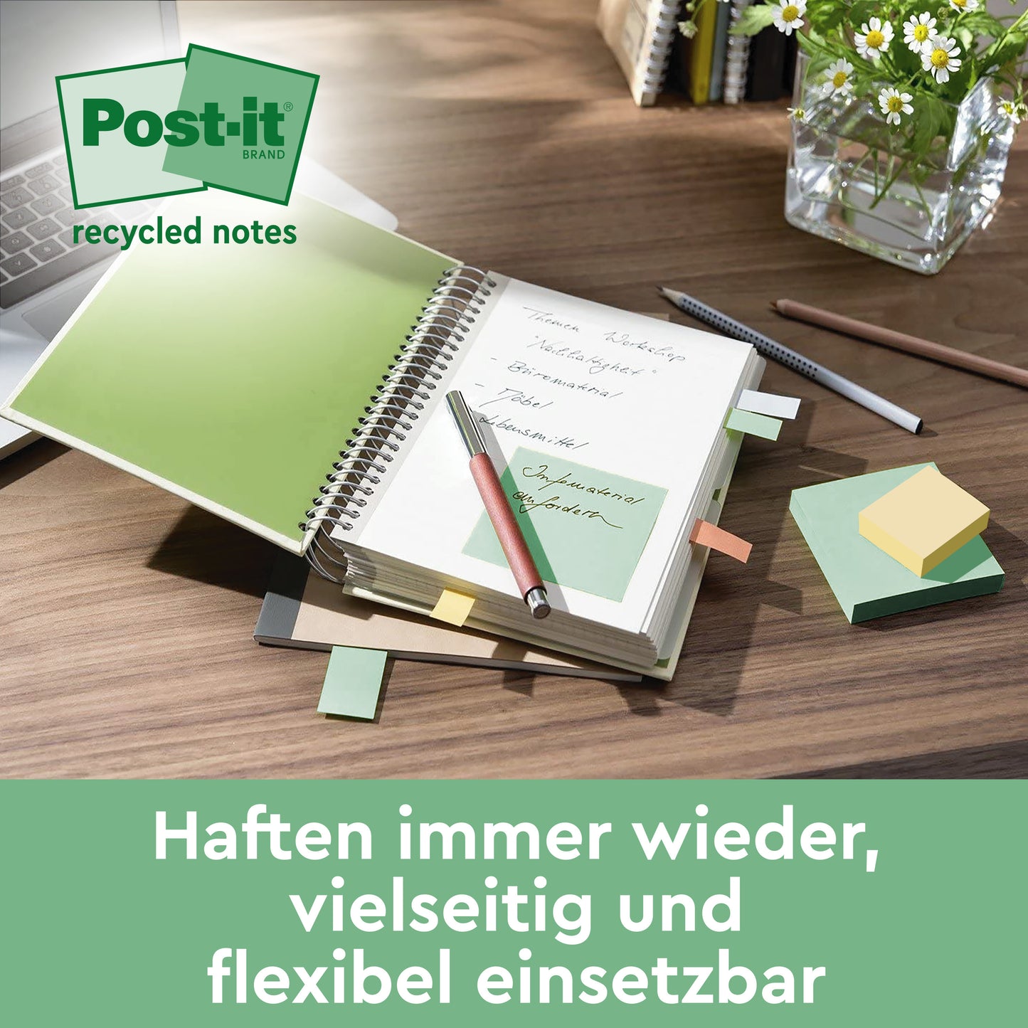 On the desk are an open notebook, a pen, and colorful Post-it® Super Sticky 100% Recycled Notes (47.6 x 47.6 mm, 70 sheets, PEFC) from 3M Deutschland GmbH. Also, a vase with green stems and a keyboard.