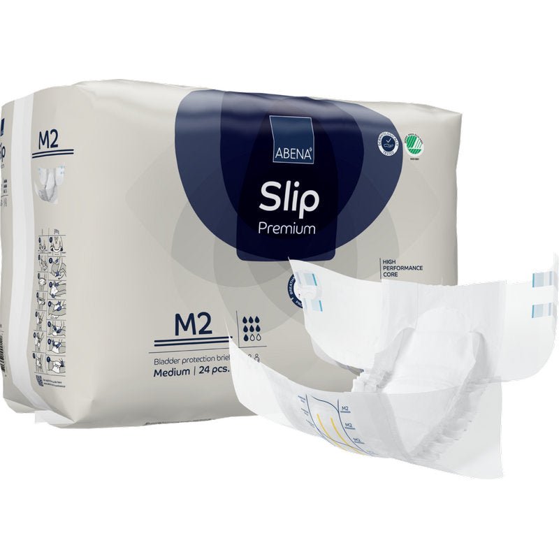 Behind an unfolded diaper is a pack of ABENA Slip Premium from Abena Re-Seller GmbH, size M2. The packaging indicates that it contains 24 medium-sized slips for reliable incontinence care.