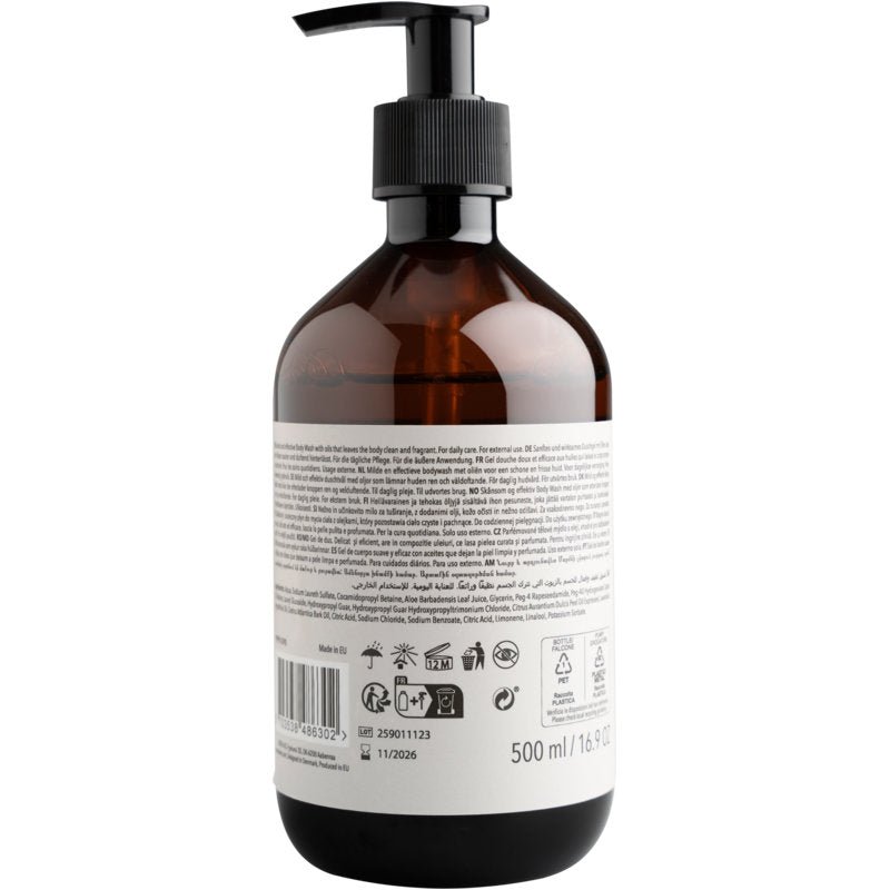 A brown plastic bottle with a black pump and a large white label displays the barcode, recycling symbols, and 500 ml volume for ENA Living Body Wash from Abena Re-Seller GmbH, sold as a carton (8 packs).