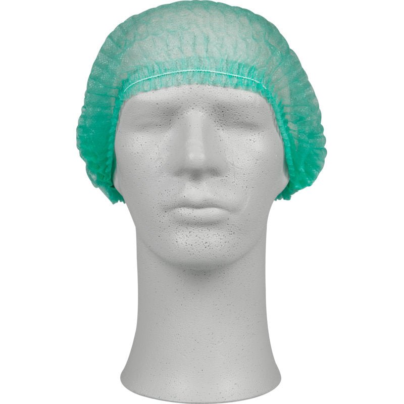 A white mannequin head wears a green clip cap, PP from Abena Re-Seller GmbH. These disposable bouffant caps provide hygienic protection and fully cover the head - ideal for use in medical facilities.