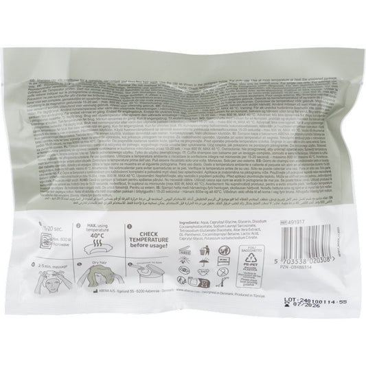 Eine versiegelte weiße Kunststoffverpackung (ø 32 cm) für Abena Re-Seller GmbH Shampoo-Haube zeigt Gebrauchsanweisung, Piktogramme, Barcode, Inhaltsstoffe und Temperaturhinweise in mehreren Sprachen. Das Design passt zur Einweg-Haube; die Schachtel enthält 30 Packungen.