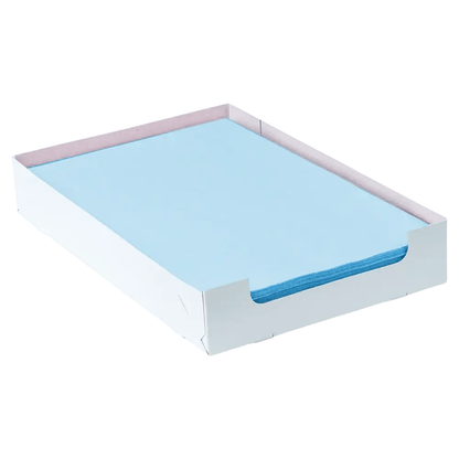 A stack of light blue AMPri Dental crepe tray filter paper, measuring 18 x 28 cm, is neatly arranged in a white cardboard tray with open sides, making it the ideal choice for efficient dental practice organization.