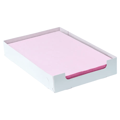 A stack of pink paper, similar to AMPri Dental crepe liner tray filter paper in various colors, is neatly arranged in a white tray. The low sides of the tray, manufactured by AMPri Handelsgesellschaft mbH, reveal the carefully aligned edges of the paper.