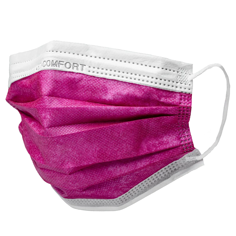 On a plain white background, a pink-white disposable face mask with ear loops is depicted. The AMPri MED-COMFORT surgical mask Type IIR by AMPri Handelsgesellschaft mbH consists of pleated layers, with 'COMFORT' printed on the white upper part.