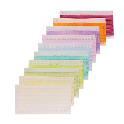 A collection of AMPri MED-COMFORT surgical mask Type IIR face masks in various colors is arranged in a diagonal line. These masks sold by AMPri Handelsgesellschaft mbH are multi-layered and feature shades of purple, orange, yellow, green, teal to beige. Each mask has ear loops and a pleated design.