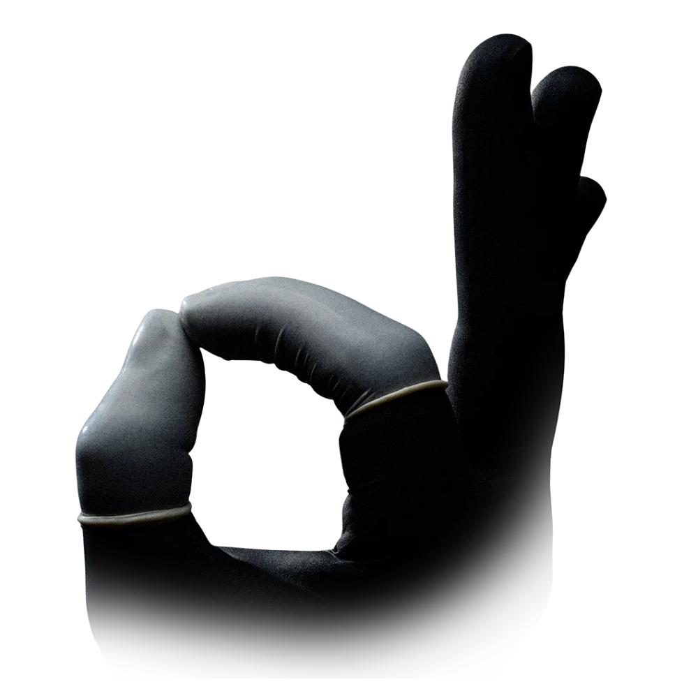 An AMPri MED-COMFORT Latex finger cot from AMPri Handelsgesellschaft mbH is depicted in black, forming an "OK" hand gesture, with the index finger and thumb creating a circle while the other fingers point upwards. The white background has a subtle gradient effect at the bottom.