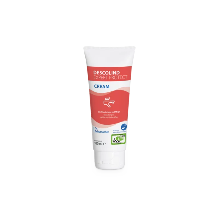 Die 100-ml-Tube Dr. Schumacher Descolind Expert Protect Cream Hautschutzcreme der Dr. Schumacher GmbH steht aufrecht auf weißem Grund mit rot-weißem Etikett - perfekt für den Handschutz bei allergiegefährdeter Haut.
