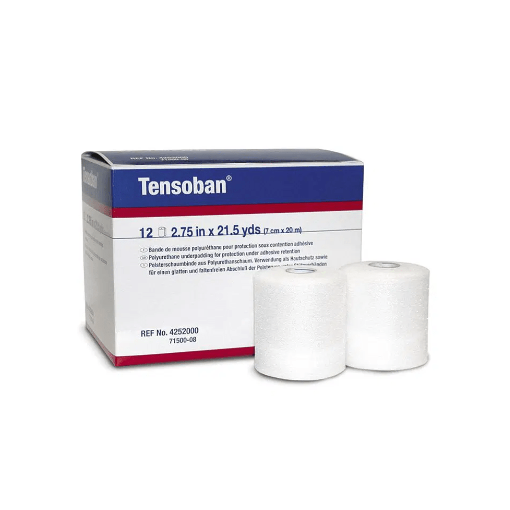 In the background, a box labeled "BSN Tensoban® Polsterschaumbinde" with the dimensions "7 cm x 20 m" catches the eye. In front, there are two neatly arranged rolls of white medical tape for skin protection, made from Polsterschaumbinde by BSN Medical GmbH.