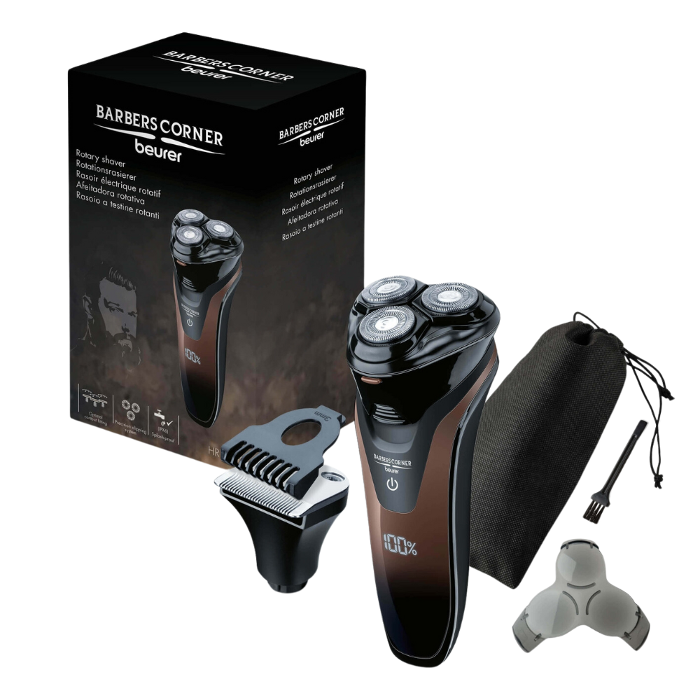 Image of a Beurer HR 8000 rotary shaver by Beurer GmbH, next to its packaging. The shaver features three rotating heads and a precision cutting system. Various accessories are next to it, including a beard and sideburn styler attachment, a travel case, and a small cleaning brush. The packaging shows brand and product details.