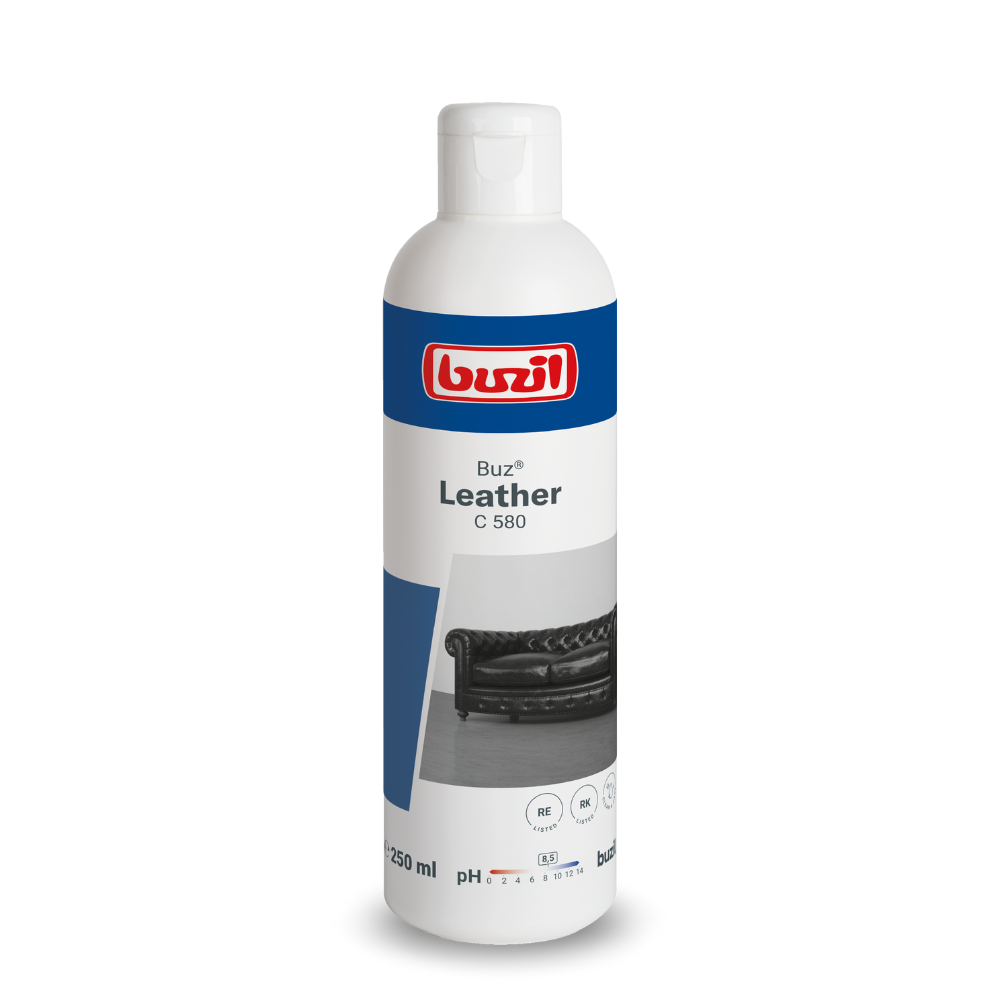 A 250 ml bottle of Buzil Buz® Leather C 580 surface intensive cleaner for smooth leather is displayed. The label with a leather sofa emphasizes its purpose as a leather care product and UV protection. The bottle is mainly white with blue accents, ideal for maintaining the pristine condition of your furniture, manufactured by BUZIL-WERK Wagner GmbH & Co. KG.
