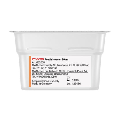 A close-up of a white CWS ParadiseLine Washroom Fragrance container for the Fragrance Dispenser Paradise Air Bar, labeled with product information, company details, "Made in Germany," and a transparent lid. Suitable for washroom fragrance systems.