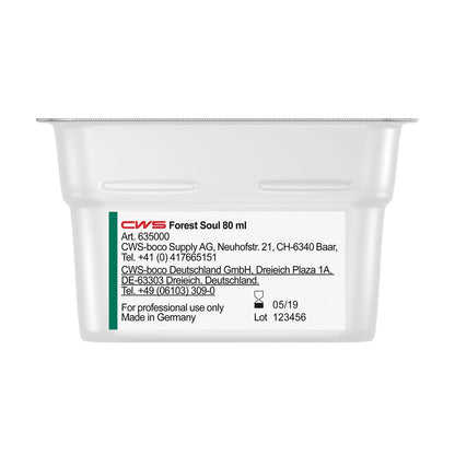 A rectangular white container labeled "CWS ParadiseLine Washroom Fragrance for Fragrance Dispenser Paradise Air Bar" by CWS displays product and company information, contact details, the manufacturing date (05/19), and the batch number (123456) on a white label.