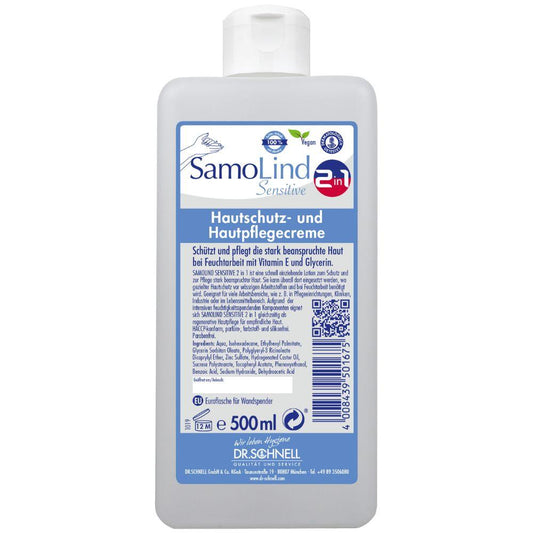 Eine 500-ml-Flasche Dr. Schnell SamoLind Sensitive 2in1 Hautschutz- und Hautpflegecreme von DR.SCHNELL GmbH & Co. KGaA mit deutschem Text, blau-weißem Etikett, Symbolen für vegane und empfindliche Haut und angereichert mit Glycerin für zusätzliche Pflege.