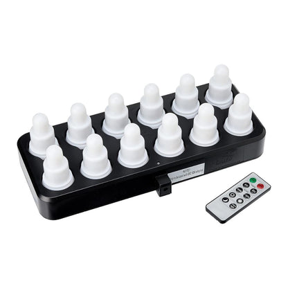 A black charging station holds twelve white, onion-shaped lights from the Duni GmbH LED Set, Warm White & Multicolor - 12 Piece Color Changing Lights. Next to it is a rectangular remote control for easy control of color and mode.
