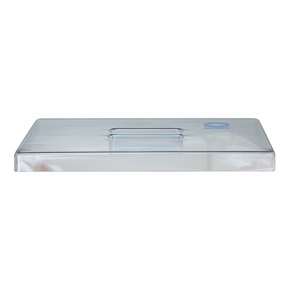 A clear, rectangular plastic lid with a small handle in the middle lies flat. The lid has a blue rectangular label in the corner. Its transparent material ensures visibility through it, making this Hartmann lid for instrument trays | piece (1 piece) from Paul Hartmann AG a practical choice for various storage purposes.