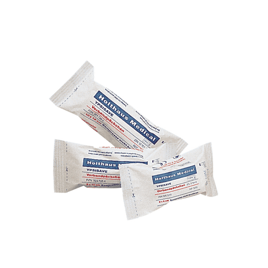 On display are three packages of Holthaus Medical YPSISAVE bandage packs, sterile, each with blue and red labeling. The text on the packaging is presumably in German and contains product information. Each package is individually wrapped and sealed, indicating that these are sterile bandage packs manufactured by Holthaus Medical GmbH & Co. KG.