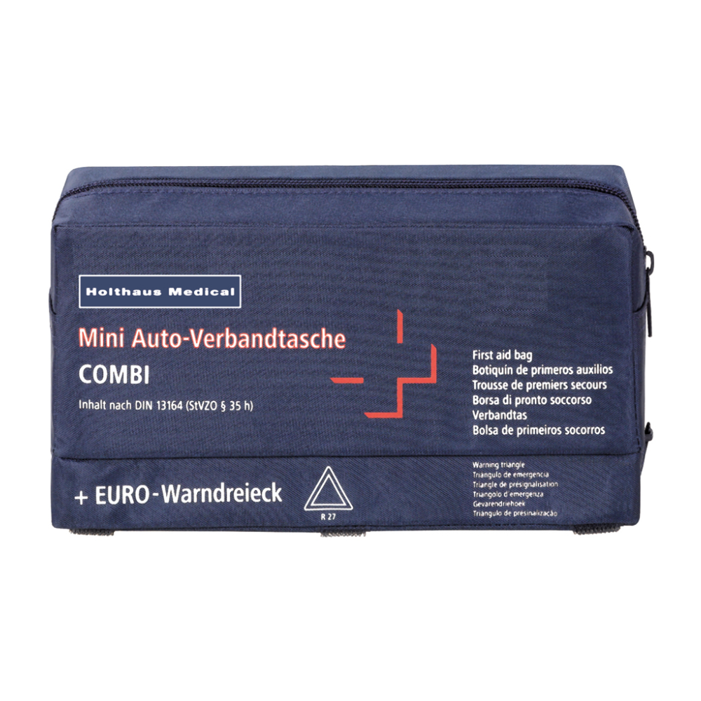 Eine marineblaue Erste-Hilfe-Tasche mit der Aufschrift „Holthaus Mini Combi Auto-Verbandtasche“ von Holthaus Medical GmbH & Co. KG, mit einem weißen Kreuz und roten Details. Der Text enthält mehrere Übersetzungen von „Erste-Hilfe-Tasche“ und erwähnt, dass der Inhalt der Norm DIN 13164 entspricht.