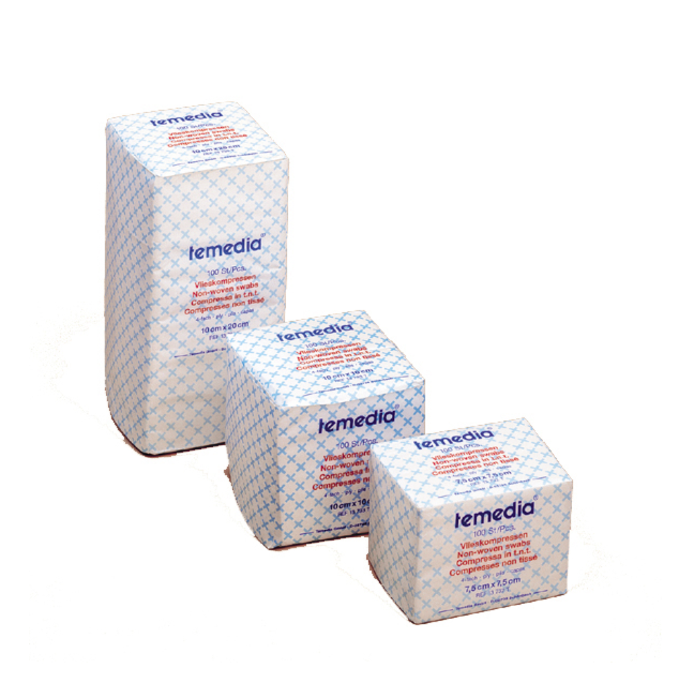 The image shows three packs of Holthaus Temedia® fleece compress in ascending order of size. The packs are white with a blue grid pattern and contain product text that describes the product and is suitable for effective wound care.