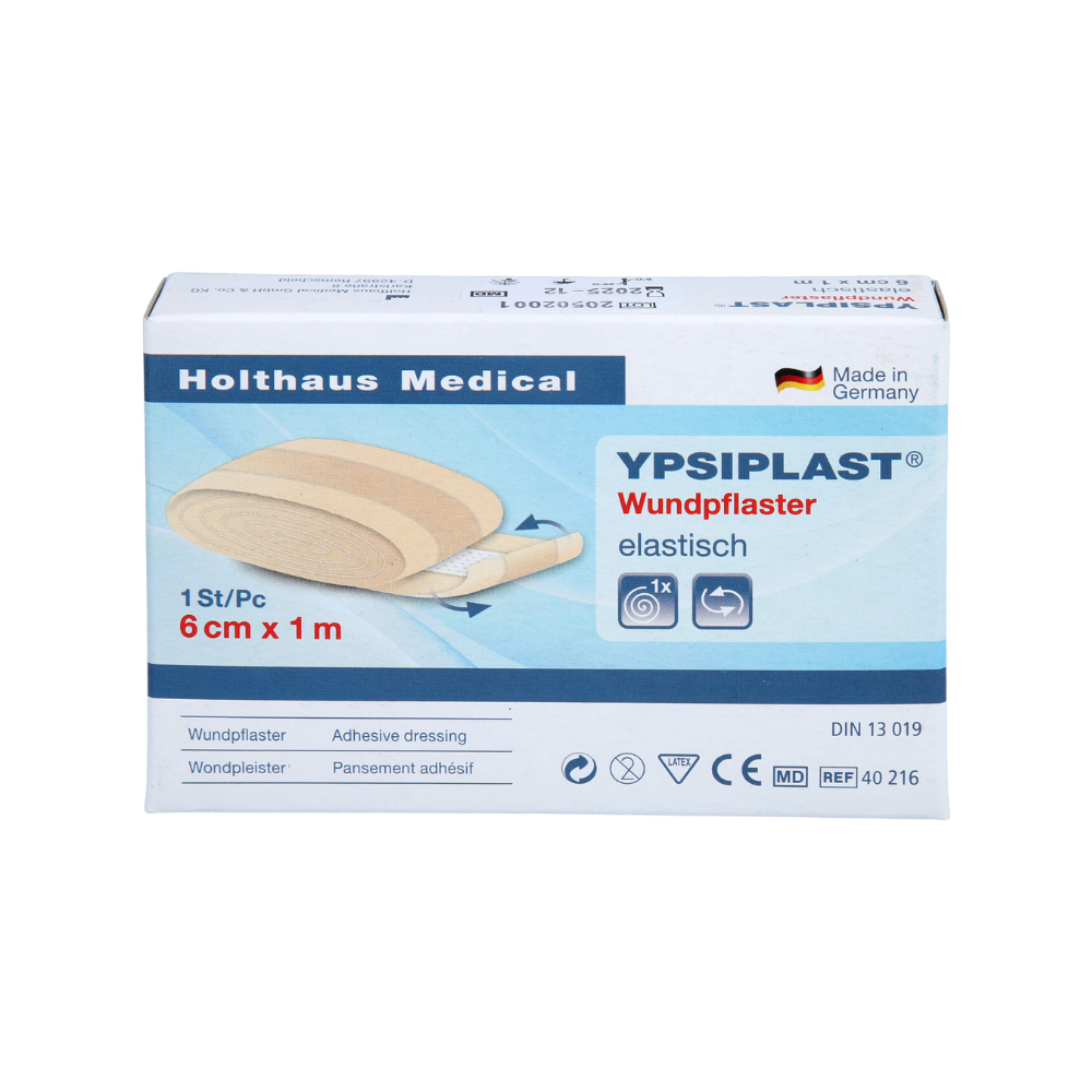 Das Bild zeigt eine Packung Holthaus Ypsiplast® Wundpflaster, elastisch - 6 cm x 1 m von Holthaus Medical GmbH & Co. KG. Die Schachtel enthält ein einzelnes Stück elastischen Heftpflasters und zeigt, dass es in Deutschland aus atmungsaktivem Gewebe hergestellt wurde. Außerdem sind mehrere Symbole und Produktspezifikationen zu sehen.