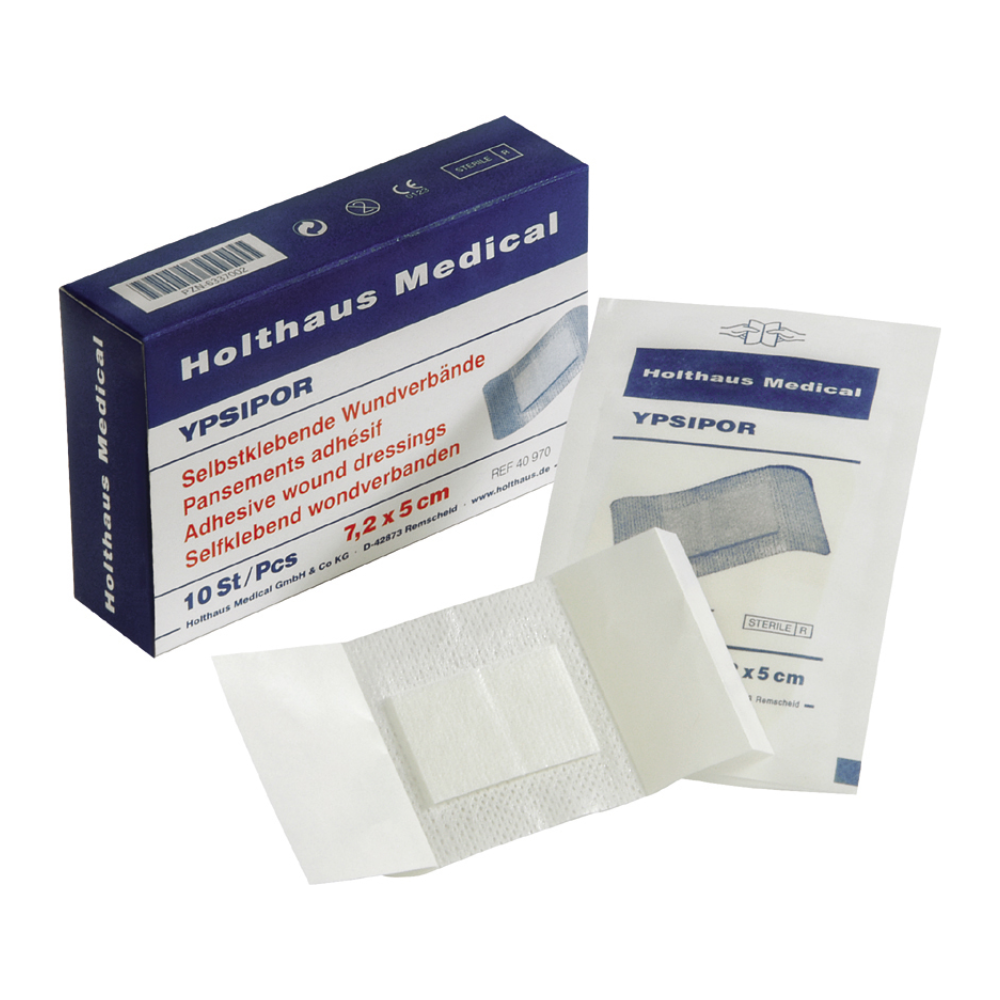 An open box of Holthaus Ypsipor wound dressing, sterile self-adhesive wound dressings, shows a single unfolded dressing next to the packaging. The box and packaging feature the brand name Holthaus Medical GmbH & Co. KG and product details in blue lettering, as well as images of the self-adhesive wound dressings.