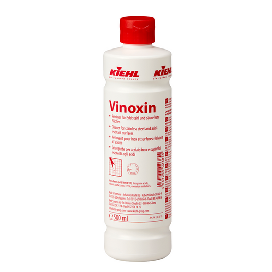 Weiße 500-ml-Flasche Johannes Kiehl KG Vinoxin Reiniger für Edelstahl und säurebeständige Flächen, mit rotem Verschluss und Etikett mit Anwendungshinweisen und Produktinformation. Erhältlich in Kartons mit 12 Flaschen.