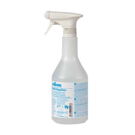Kiehl RapiDés Flüssiger Schnelldesinfektionsreiniger der Johannes Kiehl KG befindet sich in einer klaren Kunststoff-Sprühflasche mit weißem Sprühkopf. Auf der Flasche befindet sich ein blau-weißes Etikett mit Produktinformation und Gebrauchsanweisung.