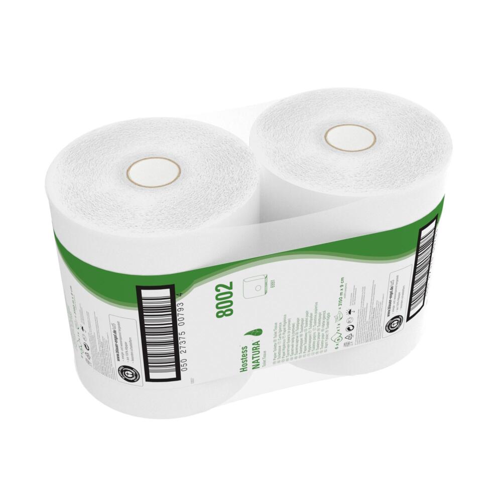 A carton contains six jumbo rolls of Hostess™ NATURA toilet paper (each 525 m, white) from Kimberly-Clark GmbH, each wrapped in plastic with a green and white label with product information and barcode.