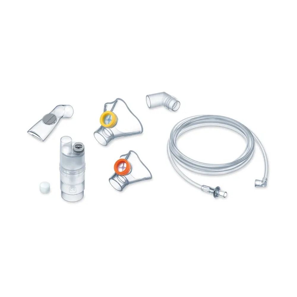 Image of the parts of Medel® Air Plus Kids Yearpack for inhaler from Beurer GmbH. Includes a transparent tube, a mouthpiece, various connectors, and a transparent container for medication. Accessory parts have different colored rings for identification. The components are arranged on a simple white background.