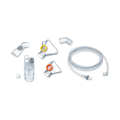 Image of the parts of Medel® Air Plus Kids Yearpack for inhaler from Beurer GmbH. Includes a transparent tube, a mouthpiece, various connectors, and a transparent container for medication. Accessory parts have different colored rings for identification. The components are arranged on a simple white background.
