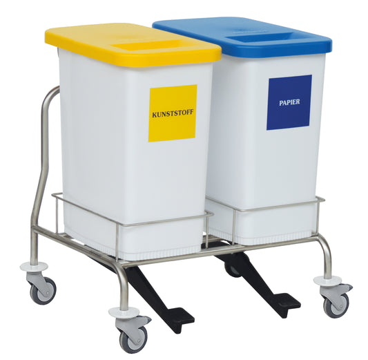 Der Novocal Wertstoffsammler Zweifachsammler besteht aus zwei rechteckigen Behältern auf einem Edelstahlwagen mit Rädern, einem gelben "Kunststoff"-Deckel links und einem blauen "Papier"-Deckel rechts, die eine effiziente Abfalltrennung gewährleisten.