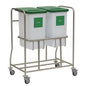 The Novocal recyclable collector combination collector consists of a stainless steel frame with four wheels, carrying two white containers labeled "GLASS" with green lids, which are attached side by side for efficient waste separation.