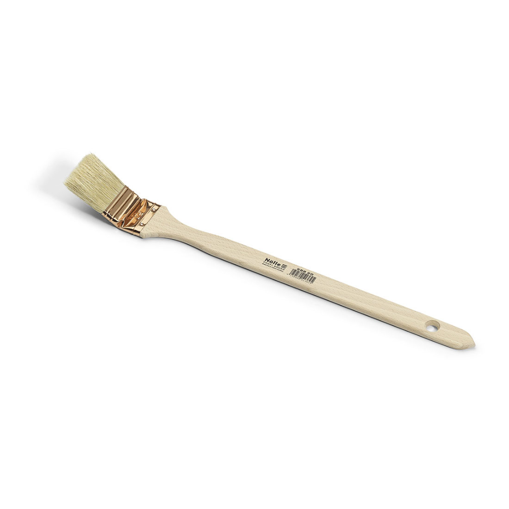 The Nölle Profi Brush radiator brush features a wooden handle with labeling and hanging hole, a copper-colored ferrule, and angled light China bristles on a white background.