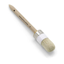 The Nölle Profi Brush painter's round brush features a round wooden handle with a metal ferrule, light bristles made of pure light Chinese bristle for excellent quality, and a white fabric trimming on the ferrule. The handle is elegantly labeled with text. Perfect for painting projects.