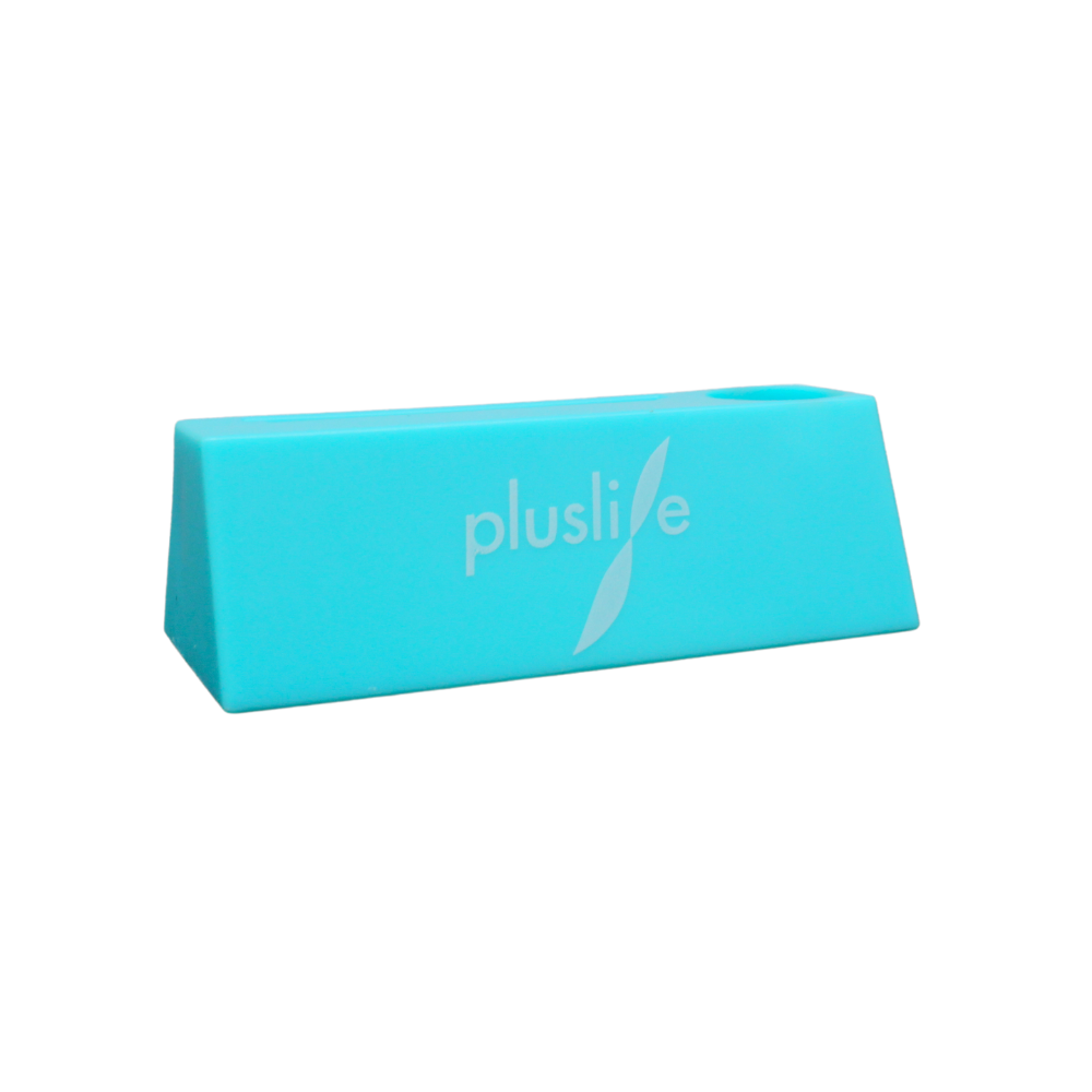 A blue, trapezoidal rubber doorstop with the brand name "pluslife" in white and a leaf design next to it. The Pluslife PCR test device, holder | pack (1 piece) has a smooth, glossy surface, making it an ideal accessory for your Pluslife PCR test device.