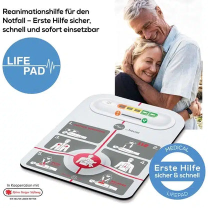 An elderly couple embraces and smiles outdoors. In the foreground, an innotas discontinued item is visible: Beurer LifePad® resuscitation aid (1 piece) with step-by-step first aid instructions and German text explaining its use in an emergency.