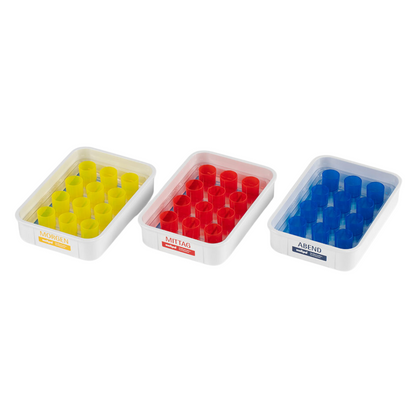 The SATZ melipul meal tray 12 with reusable cup from Helmut Schwarz GmbH is perfect for precise medication distribution. It contains three pill dispensers with German labeling: "Morning" with yellow compartments, "Noon" with red, and "Evening" with blue compartments. Each pill dispenser is ideal for care facilities and features eight compartments to simplify daily medication intake.
