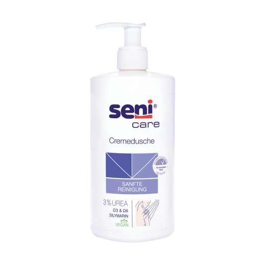 Eine Flasche Seni Care Cremedusche mit 3% Urea – 500 ml | Spender (500 ml) von TZMO Deutschland GmbH mit Pumpspender. Das Etikett ist weiß mit blauen und violetten Akzenten und dem Text „SANFTE REINIGUNG“, „3% UREA“, „SILIMARIN“ und „VEGAN“. Ideal für trockene Haut, die Abbildung der Hände unten weist auf die schonende Anwendung hin.