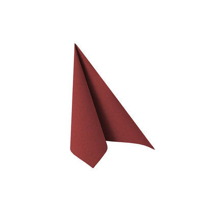 A single, elaborately folded red napkin from the PAPSTAR "ROYAL Collection" napkins 1/4-fold 40 cm x 40 cm from PAPSTAR GmbH stands upright against a plain white background. This sophisticated piece of table decoration is characterized by a smooth texture, with the edges forming a perfect triangular shape.