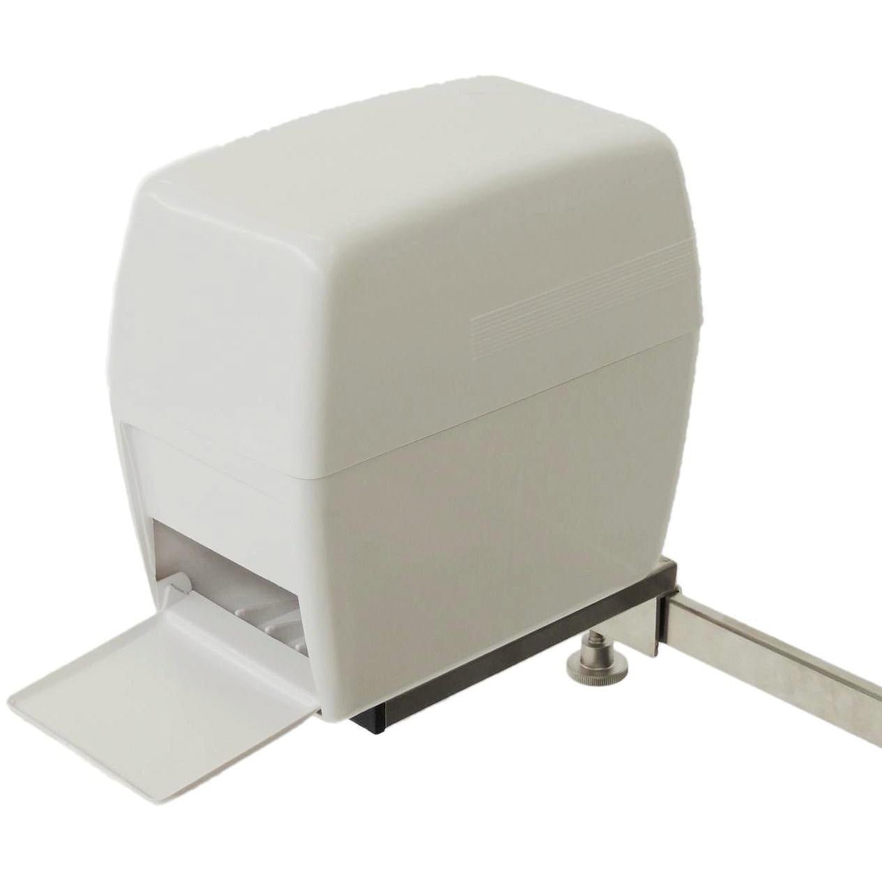 A white automatic sliding gate drive with a rectangular housing and mounted metal rack is shown with an open front cover, revealing part of the internal mechanism - a precision comparable to that of the Novocal swab dispenser for Euro rail.