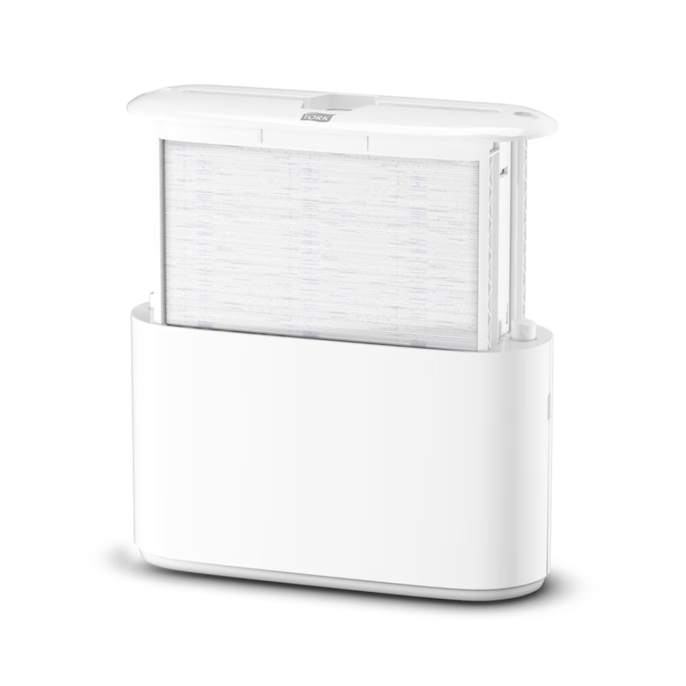 The Tork Xpress® 552200 Tabletop Dispenser for Multifold Hand Towels Elevation H2 from TORK - Essity Professional Hygiene Germany GmbH impresses with a sleek, minimalist design featuring a visible filter integrated into the base. The vertically positioned filter enhances the overall aesthetics, and the top is slightly open to demonstrate its efficient functionality.